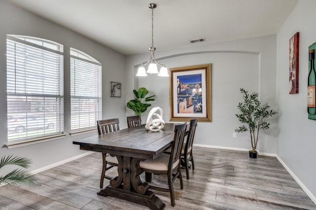 9807 Asheboro St, Frisco, TX 75035 - dining area with healthy amount of natural light, wood finished floors, baseboards, and a chandelier