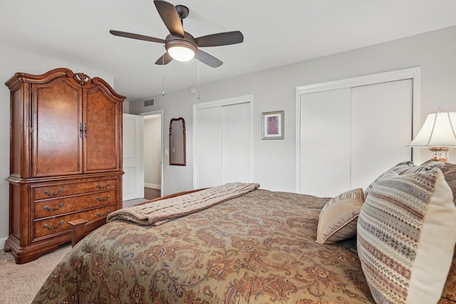 612 Twilight Trl, Richardson, TX 75080 - carpeted bedroom featuring two closets and a ceiling fan