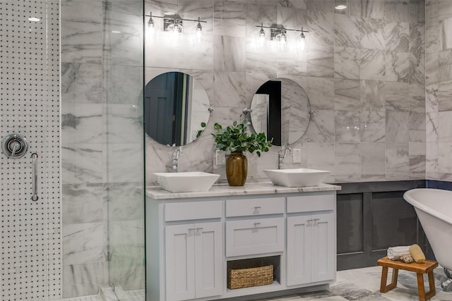 936 N Windomere Ave, Dallas, TX 75208 - bathroom with double vanity, a shower stall, a soaking tub, and tile walls