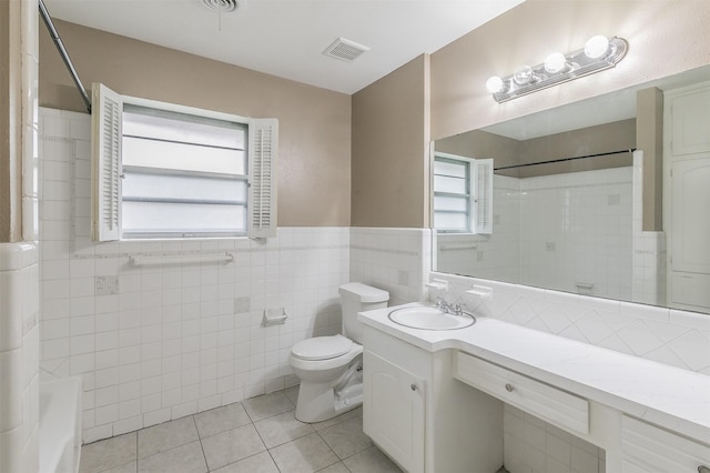 5113 S Drive, Fort Worth, TX 76132 - full bath with tile patterned floors, tile walls, toilet, vanity, and a wainscoted wall