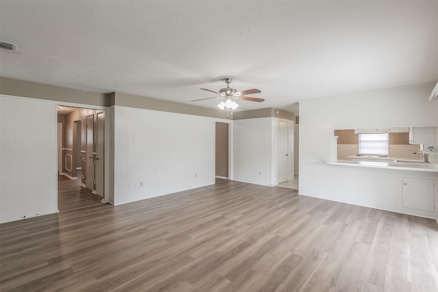 5113 S Drive, Fort Worth, TX 76132 - unfurnished living room with a ceiling fan, a sink, and wood finished floors