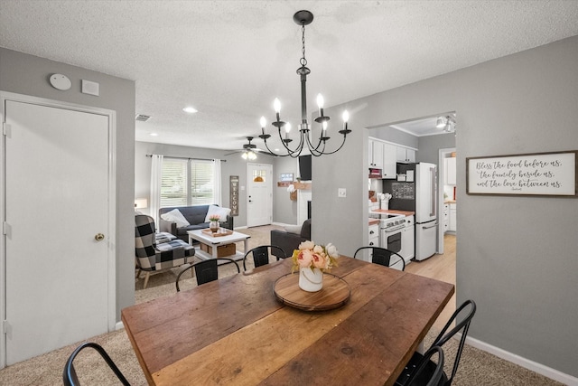 3809 Springtime Ct, Arlington, TX 76017 - dining space featuring a chandelier, light carpet, a ceiling fan, baseboards, and a textured ceiling