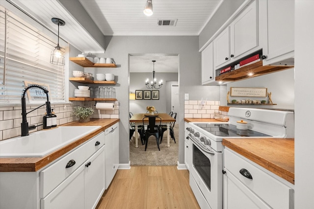 3809 Springtime Ct, Arlington, TX 76017 - kitchen featuring white appliances, light wood-style floors, wood counters, a sink, and decorative backsplash