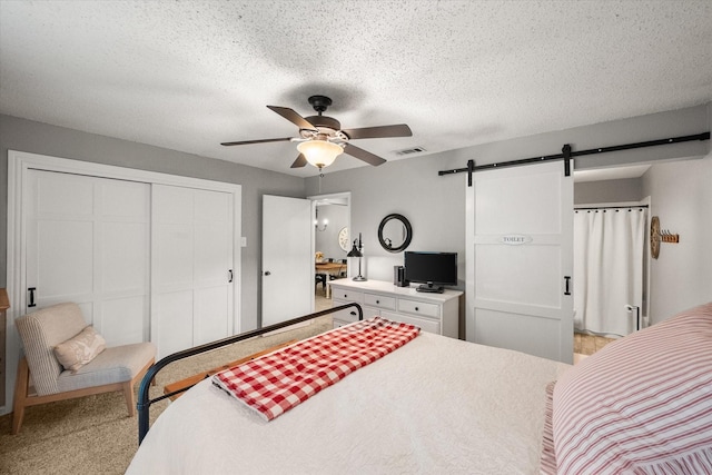 3809 Springtime Ct, Arlington, TX 76017 - bedroom featuring a barn door, a closet, and a ceiling fan