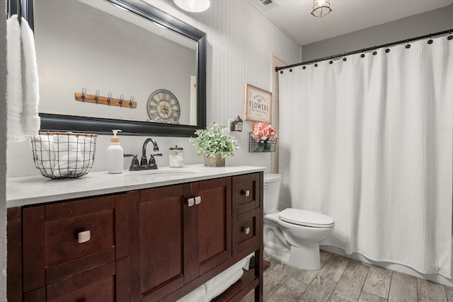 3809 Springtime Ct, Arlington, TX 76017 - bathroom with toilet, vanity, wood finished floors, and a shower with shower curtain