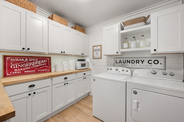 3809 Springtime Ct, Arlington, TX 76017 - laundry room with washer and dryer, cabinet space, and light wood-type flooring