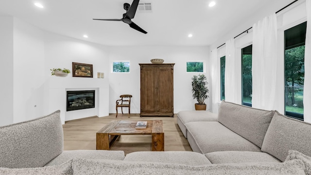 141 Lakeside Dr, Lipan, TX 76462 - living area with recessed lighting, light wood-style flooring, a glass covered fireplace, and ceiling fan