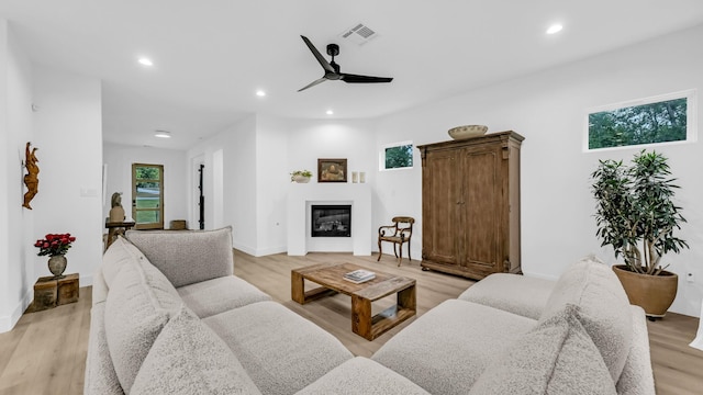 141 Lakeside Dr, Lipan, TX 76462 - living room featuring ceiling fan, light wood-style flooring, a glass covered fireplace, and recessed lighting