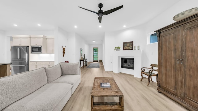141 Lakeside Dr, Lipan, TX 76462 - living room with ceiling fan, recessed lighting, light wood-style flooring, and a glass covered fireplace