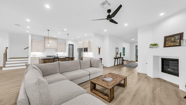 141 Lakeside Dr, Lipan, TX 76462 - living area featuring light wood-style floors, recessed lighting, ceiling fan, stairway, and baseboards