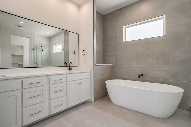 141 Lakeside Dr, Lipan, TX 76462 - full bathroom with plenty of natural light, double vanity, a soaking tub, and a stall shower