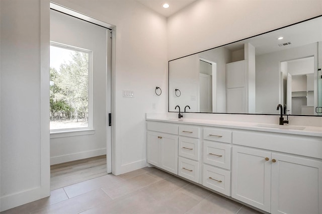 141 Lakeside Dr, Lipan, TX 76462 - bathroom featuring double vanity, tile patterned floors, healthy amount of natural light, baseboards, and recessed lighting