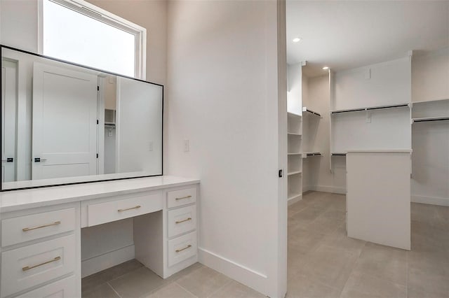 141 Lakeside Dr, Lipan, TX 76462 - bathroom featuring tile patterned floors, a walk in closet, vanity, baseboards, and recessed lighting