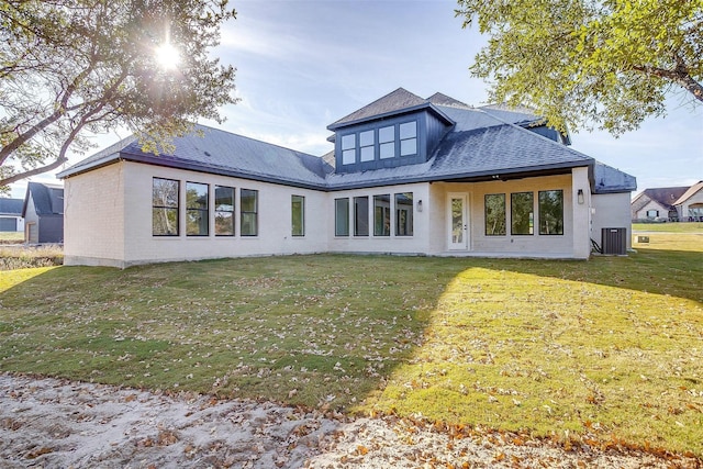 141 Lakeside Dr, Lipan, TX 76462 - rear view of house featuring central air condition unit, a lawn, brick siding, and a shingled roof