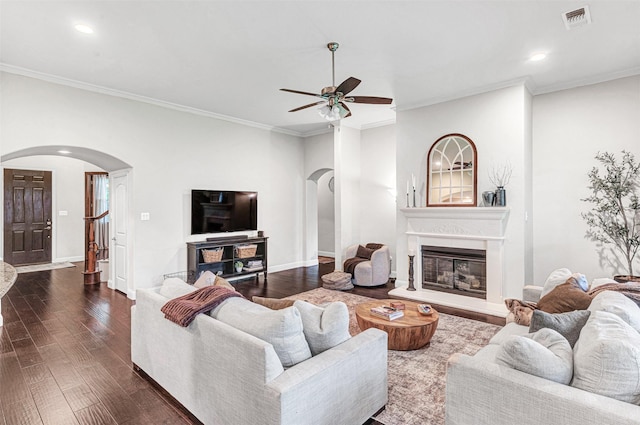 1200 Thornberry Dr, Mckinney, TX 75071 - living area with arched walkways, a ceiling fan, dark wood-style flooring, recessed lighting, and crown molding
