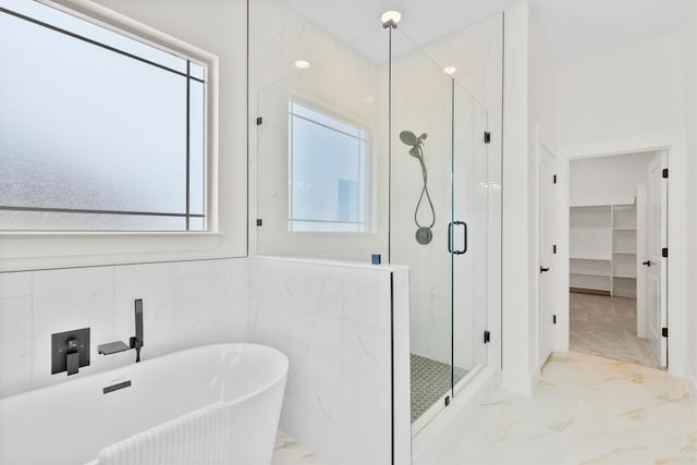 1128 Dixie Estates Way, Whitesboro, TX 76273 - full bath featuring marble tiled flooring, a freestanding tub, a marble finish shower, and a spacious closet