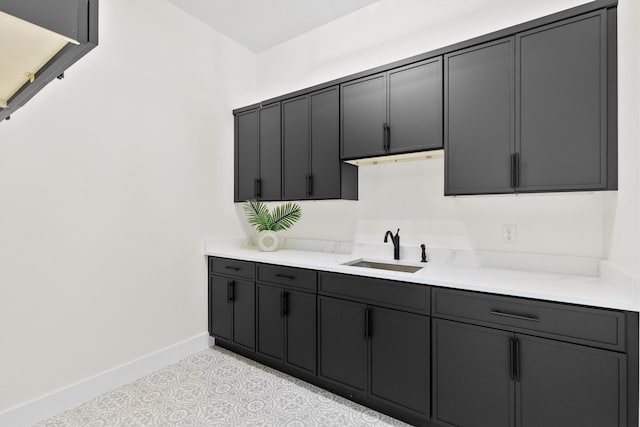 1128 Dixie Estates Way, Whitesboro, TX 76273 - kitchen featuring a sink, baseboards, and light countertops