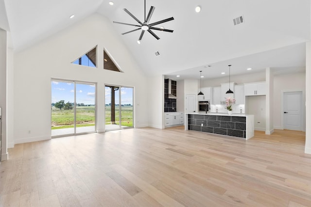 1128 Dixie Estates Way, Whitesboro, TX 76273 - unfurnished living room with baseboards, high vaulted ceiling, light wood-style flooring, recessed lighting, and ceiling fan