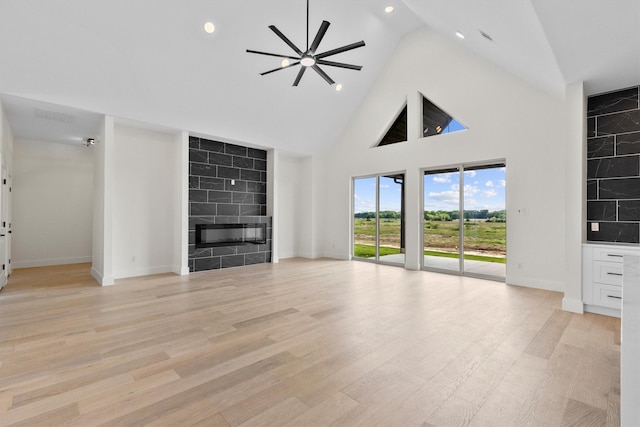 1128 Dixie Estates Way, Whitesboro, TX 76273 - unfurnished living room featuring a premium fireplace, high vaulted ceiling, baseboards, recessed lighting, and light wood finished floors