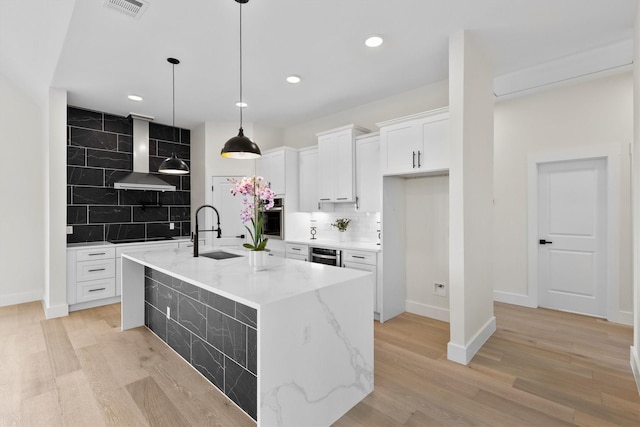 1128 Dixie Estates Way, Whitesboro, TX 76273 - kitchen featuring a sink, wall chimney range hood, oven, backsplash, and white cabinetry