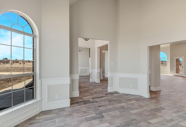 1022 Foolish Pleasure Dr, Terrell, TX 75160 - unfurnished room with a high ceiling, light wood-type flooring, and a wainscoted wall