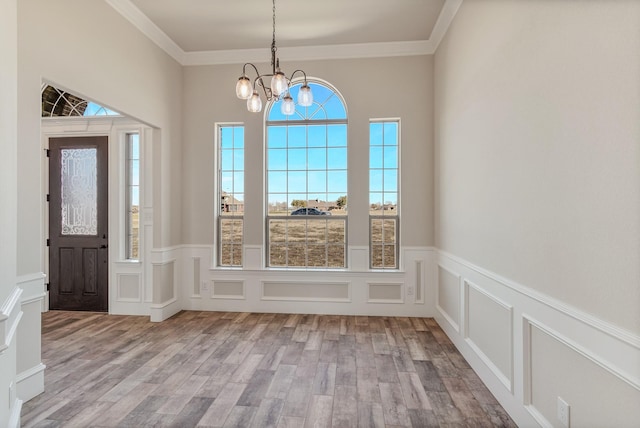 1022 Foolish Pleasure Dr, Terrell, TX 75160 - foyer featuring a decorative wall, a chandelier, plenty of natural light, wood finished floors, and ornamental molding