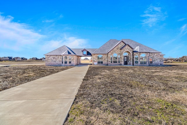1022 Foolish Pleasure Dr, Terrell, TX 75160 - french country style house with brick siding, roof with shingles, and a front yard