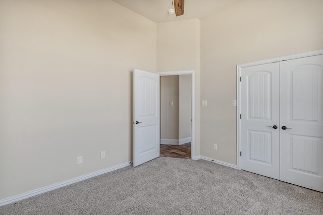 1022 Foolish Pleasure Dr, Terrell, TX 75160 - unfurnished bedroom with carpet flooring, baseboards, a towering ceiling, and a closet