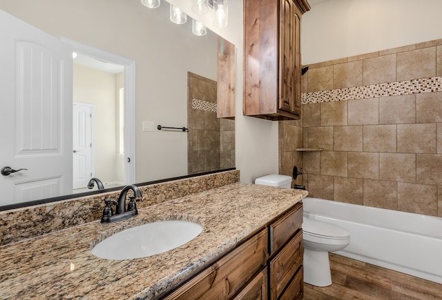 1022 Foolish Pleasure Dr, Terrell, TX 75160 - bathroom with toilet, vanity, wood finished floors, and shower / bathtub combination