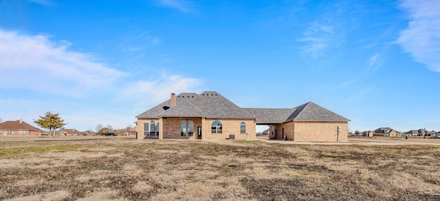1022 Foolish Pleasure Dr, Terrell, TX 75160 - rear view of house featuring a chimney and brick siding