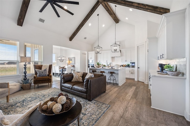 4665 Christie Ave, Caddo Mills, TX 75135 - living area featuring beam ceiling, high vaulted ceiling, a ceiling fan, wood finished floors, and recessed lighting