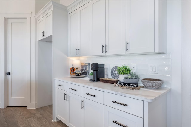 4665 Christie Ave, Caddo Mills, TX 75135 - kitchen with tasteful backsplash, light countertops, light wood-type flooring, and white cabinets