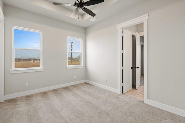 4665 Christie Ave, Caddo Mills, TX 75135 - empty room featuring light carpet, baseboards, ceiling fan, and a tray ceiling
