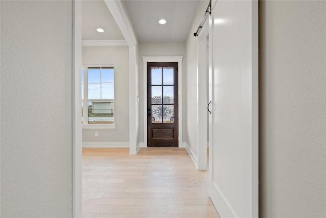4665 Christie Ave, Caddo Mills, TX 75135 - doorway with baseboards, light wood-type flooring, recessed lighting, a barn door, and ornamental molding