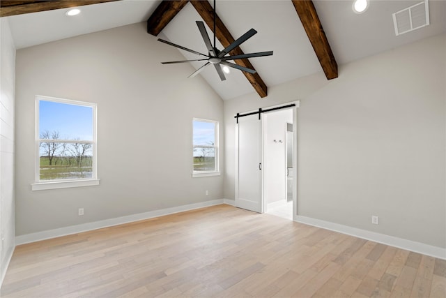 4665 Christie Ave, Caddo Mills, TX 75135 - unfurnished bedroom featuring a barn door, beamed ceiling, light wood finished floors, multiple windows, and recessed lighting