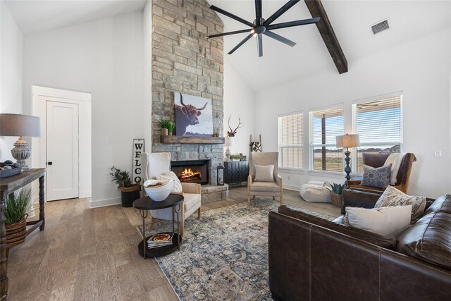 4665 Christie Ave, Caddo Mills, TX 75135 - living room with high vaulted ceiling, a stone fireplace, wood finished floors, ceiling fan, and baseboards