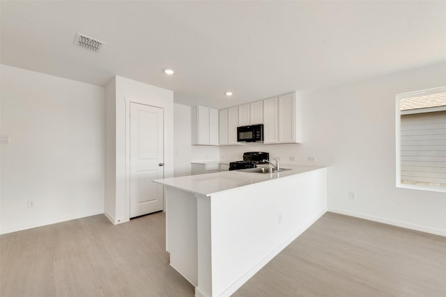 4900 Arden Springs Ave, Fort Worth, TX 76179 - kitchen with black appliances, light wood-style flooring, baseboards, recessed lighting, and light countertops