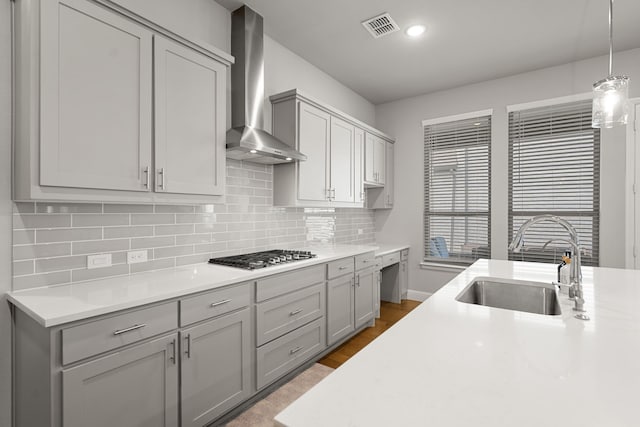 11415 Four Roses Trl, Frisco, TX 75035 - kitchen featuring wall chimney range hood, a sink, stainless steel gas cooktop, light countertops, and decorative backsplash