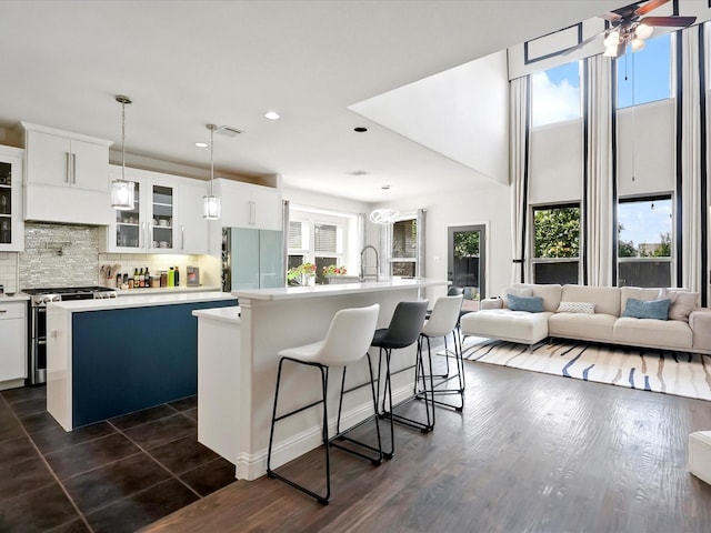 2505 Trailhead Dr, Fort Worth, TX 76177 - kitchen with stainless steel gas range, a kitchen island with sink, freestanding refrigerator, light countertops, and recessed lighting