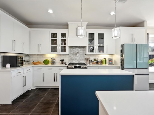 2505 Trailhead Dr, Fort Worth, TX 76177 - kitchen with freestanding refrigerator, stove, tasteful backsplash, and glass insert cabinets