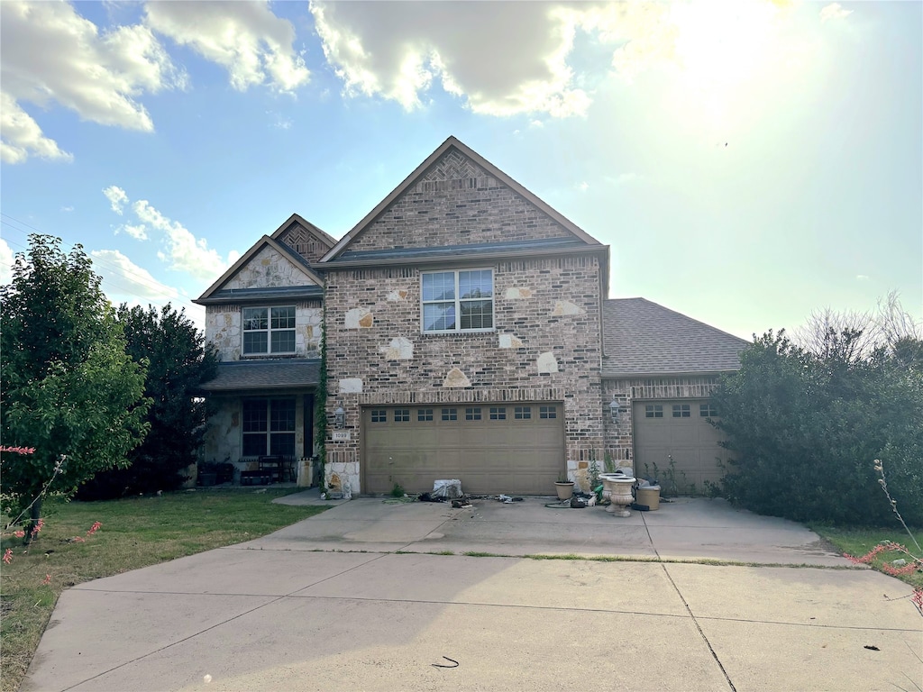 1099 Missouri St, Celina, TX 75009 - traditional home featuring driveway, stone siding, an attached garage, and a front yard