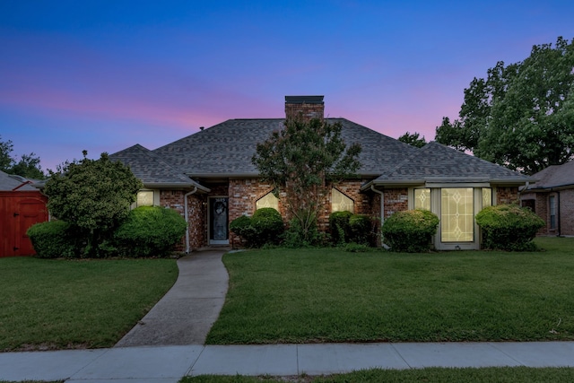 2605 Pickwick Ln, Plano, TX 75093 - view of front of house with a chimney, a yard, and brick siding