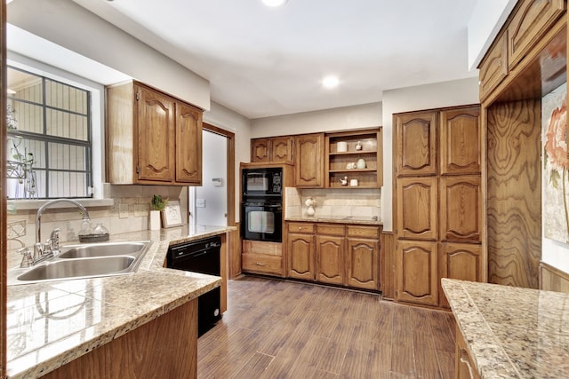 2605 Pickwick Ln, Plano, TX 75093 - kitchen with black appliances, a sink, brown cabinetry, tasteful backsplash, and dark wood-type flooring