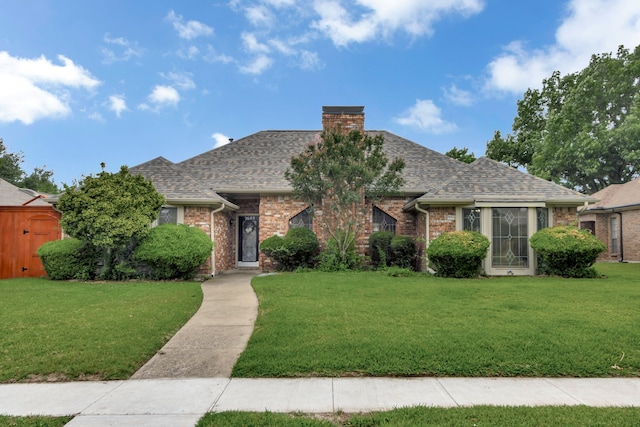 2605 Pickwick Ln, Plano, TX 75093 - view of front of house featuring brick siding, a front yard, and a shingled roof
