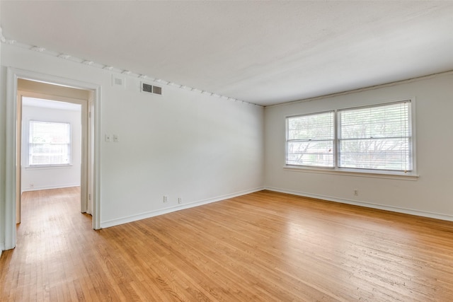 2109 Blake Ave, Dallas, TX 75228 - spare room featuring healthy amount of natural light, light wood-style flooring, and baseboards