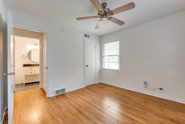 2109 Blake Ave, Dallas, TX 75228 - unfurnished bedroom with light wood-style floors, baseboards, and a ceiling fan