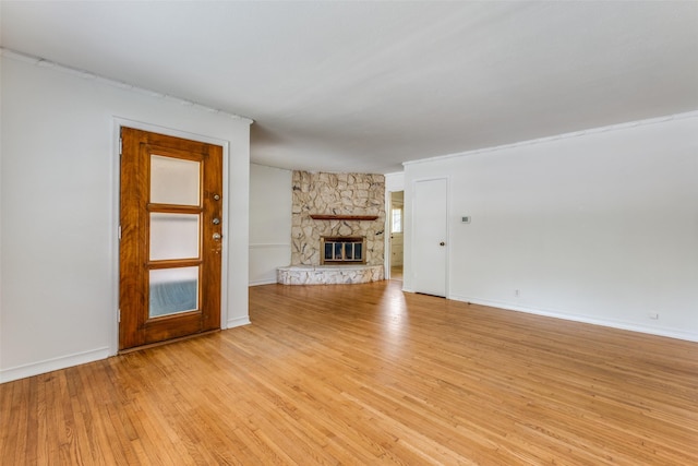 2109 Blake Ave, Dallas, TX 75228 - unfurnished living room with light wood-style floors, a fireplace, and baseboards