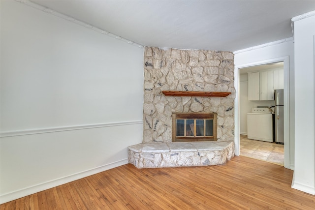 2109 Blake Ave, Dallas, TX 75228 - unfurnished living room with washer / clothes dryer, wood finished floors, baseboards, and a fireplace