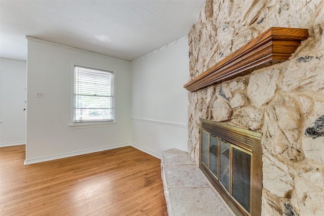2109 Blake Ave, Dallas, TX 75228 - unfurnished living room with light wood-type flooring, a large fireplace, and baseboards