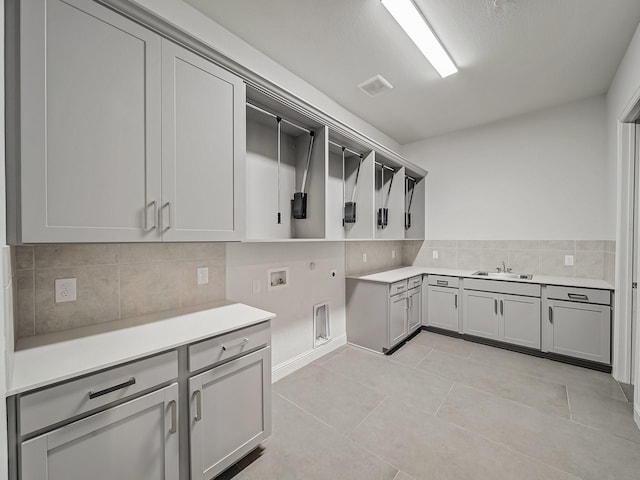 3509 Meridian Dr, Northlake, TX 76226 - washroom featuring cabinet space, hookup for a washing machine, gas dryer hookup, light tile patterned floors, and hookup for an electric dryer